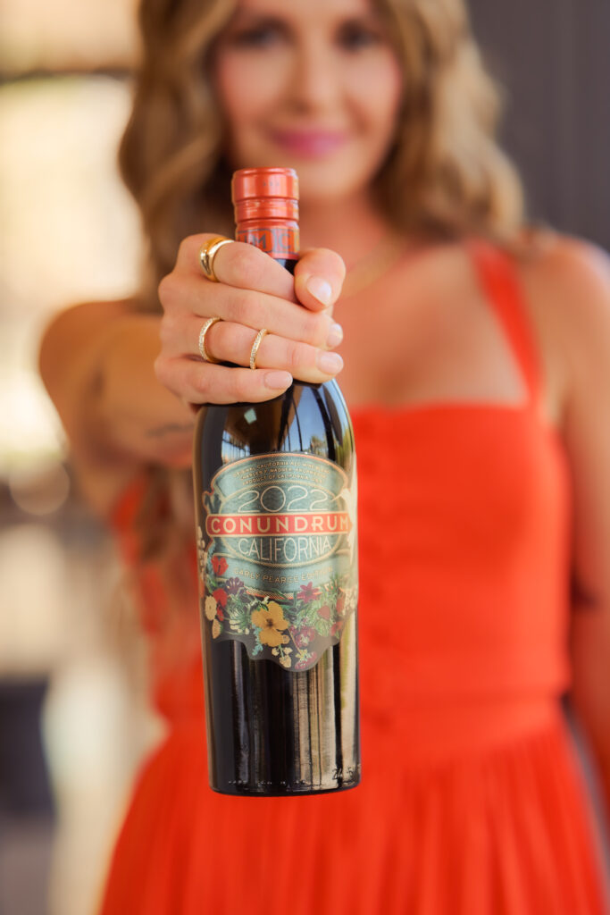 Carly Pearce holding Conundrum Wine bottle